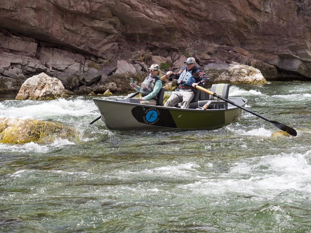 Laurel Crossland videos the excitement of running Red Creek Rapids while Scott Barrus, owner of Spinner Fall Guide Service, adroitly handles the oars.