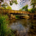 Letort Spring Run flowing under a foot bridge as it winds through a quiet and peaceful meadow. By Jay Himes Photo