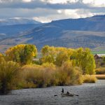 Fly fisherman on a drift boat on a Montana river