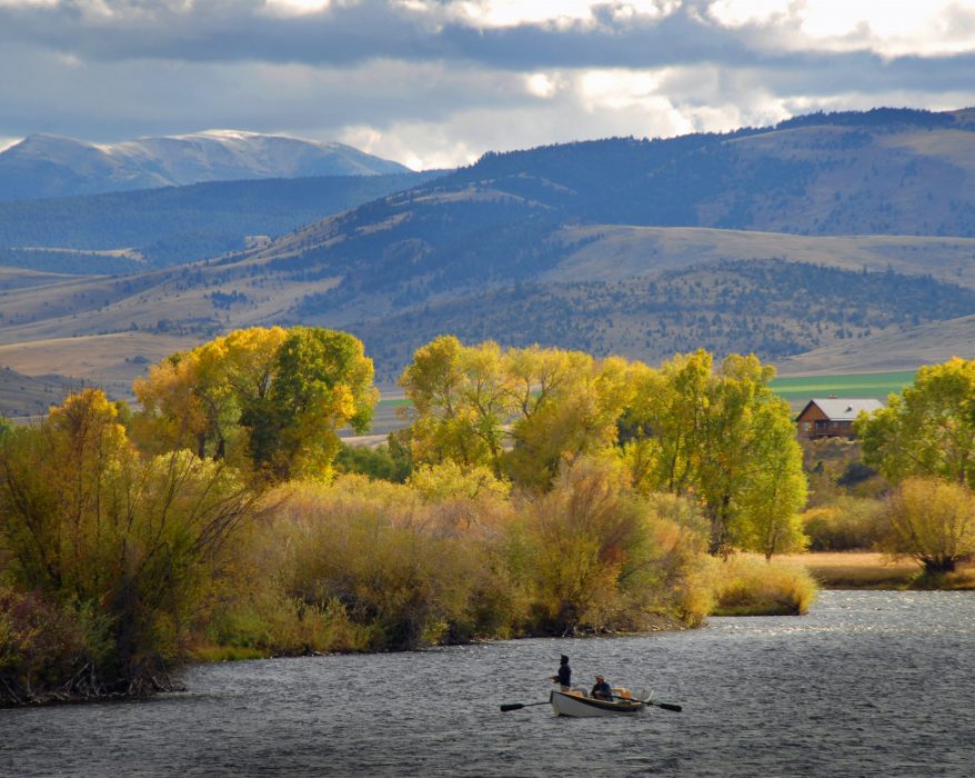 Fly fisherman on a drift boat on a Montana river