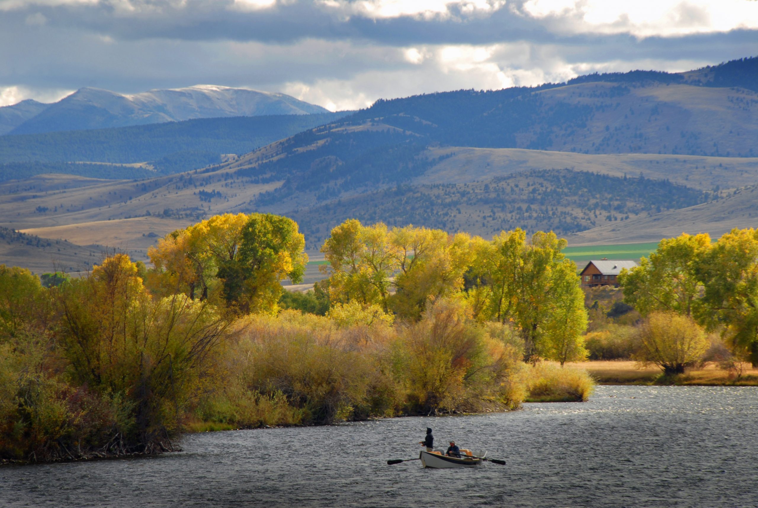 Fly fisherman on a drift boat on a Montana river